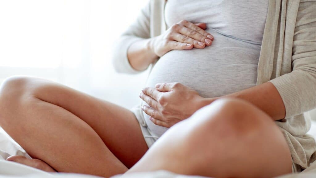 Pregnant woman holding bump