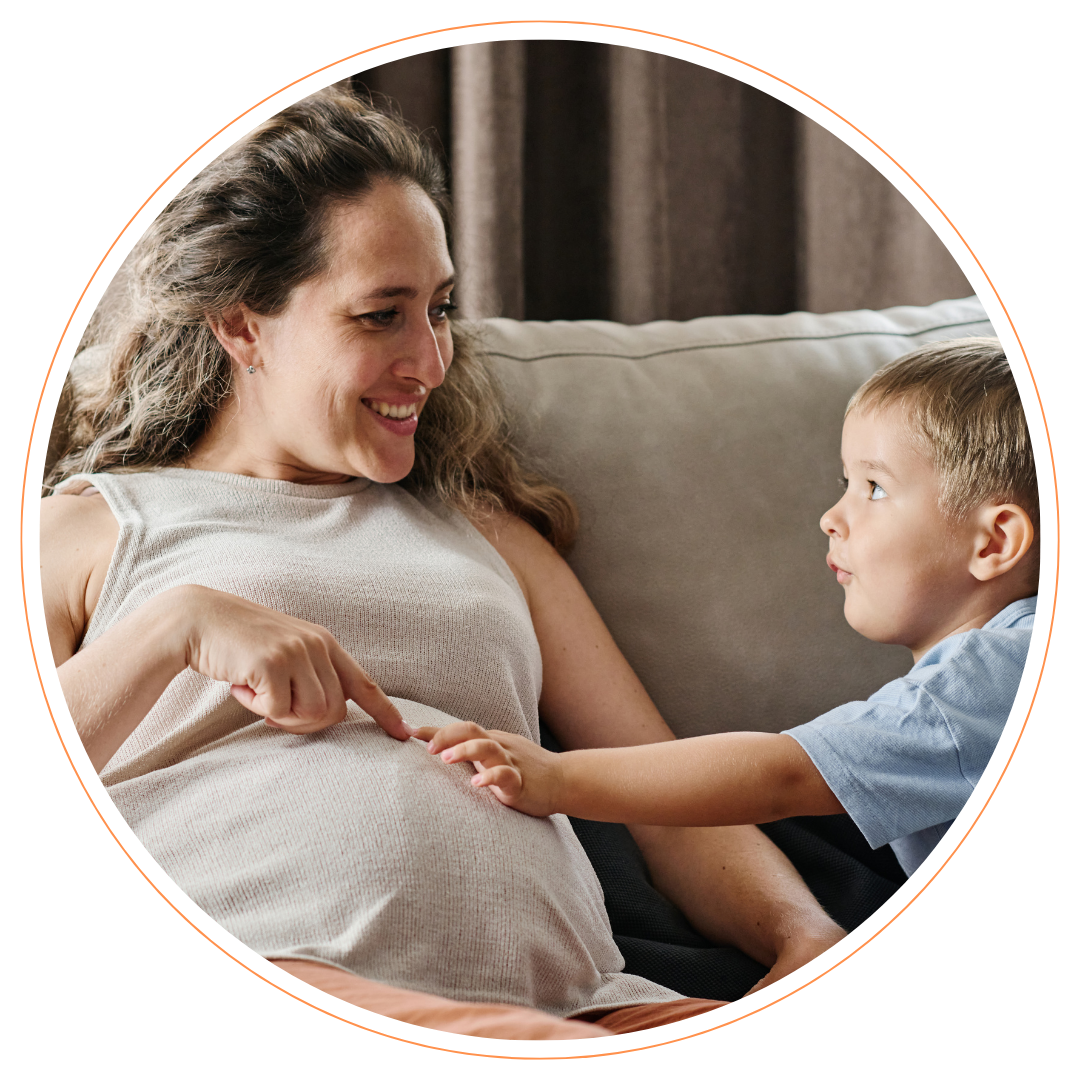 Pregnant-woman-and-small-child Pregnant woman and small child holding bump